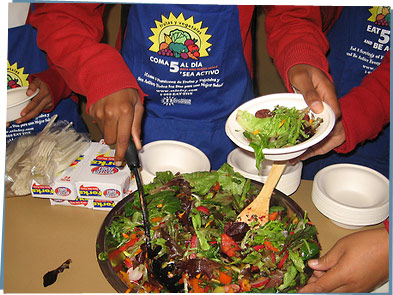 Kids serving salad at school