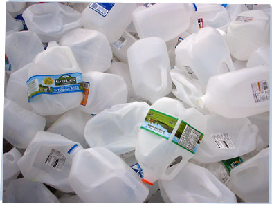 Large pile of empty plastic jugs