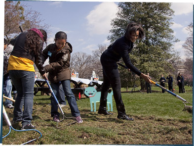 Michelle Obama gardening with some students