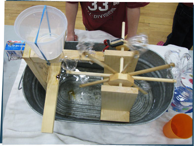 A homemade water wheel made from a washbasin and wood