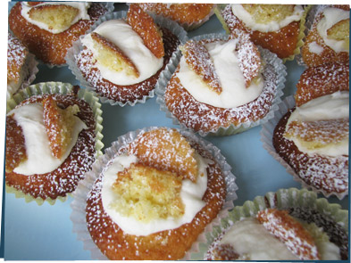 Yellow cupcakes with white dollops of frosting