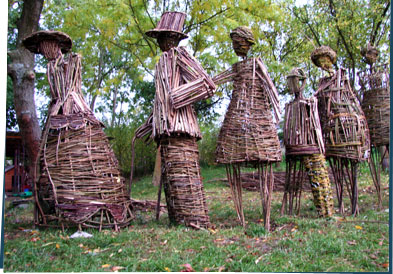 Branch sculptures of people standing in line