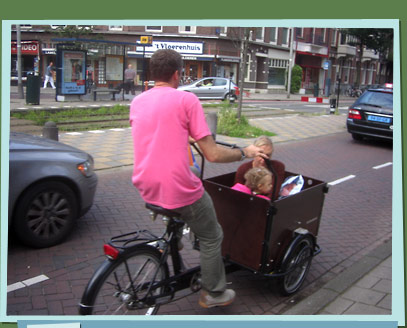 Cyclist carrying kids in box