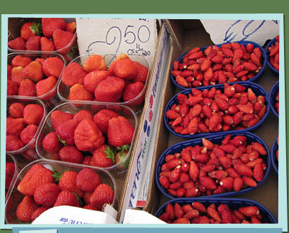 Boxes of strawberries in a stall.