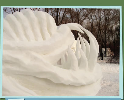 Snow sculpture of a mouth with large teeth