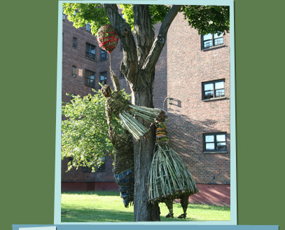 Branch sculptures of people being carried away by a balloon