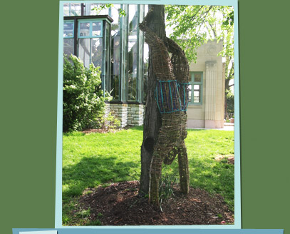 Branch sculpture of a man doing a handstand