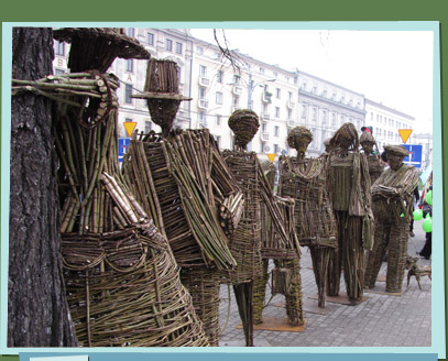 Branch sculptures of people waiting in line to hug a tree