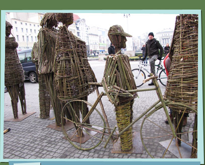 Branch sculptures of people and a bike