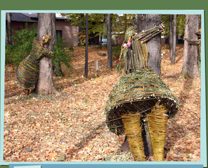 Branch sculptures of people hugging trees in the woods