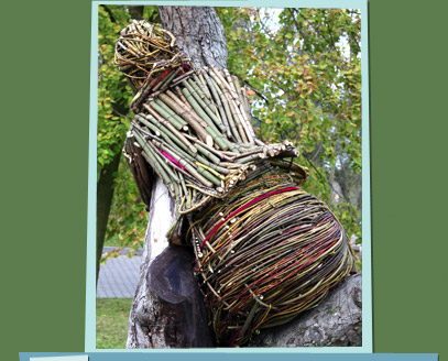 Branch sculpture of a woman sitting in a tree