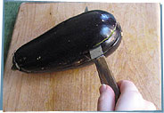 Knife slicing eggplant